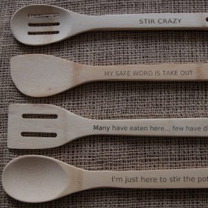 A set of four bamboo kitchen tools with funny quotes laser engraved